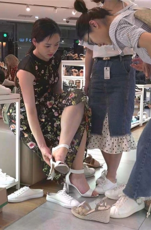 美脚女孩在鞋店试鞋子的场景